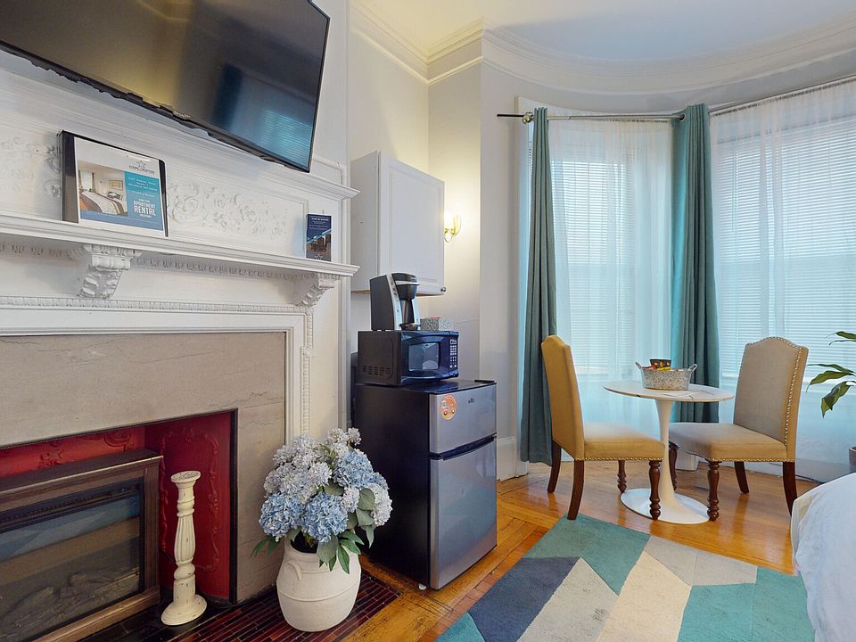Round table for dining or working, Mini-fridge, wall mounted flat-screen TV