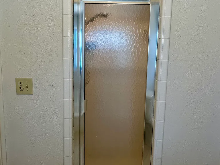 Primary bathroom shower stall with garden tub