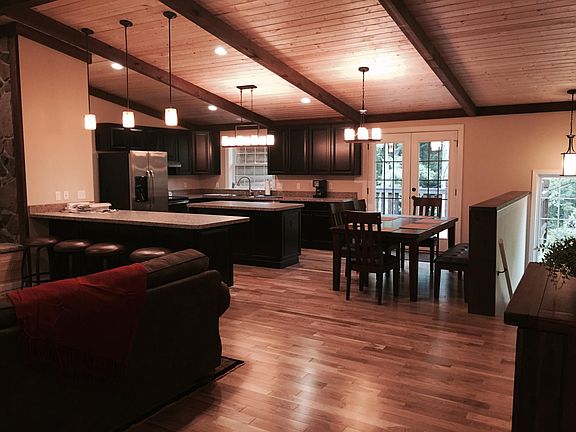High ceilings, wooden beams, and modern updates throughout this stylish, cabin-style home!