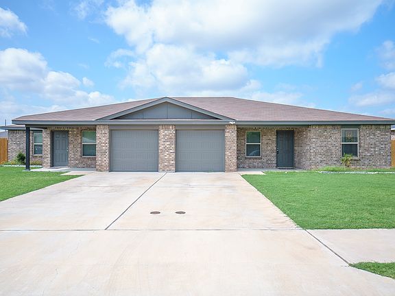 Front exterior view of the duplex, with the entrance to Unit B positioned on the left.