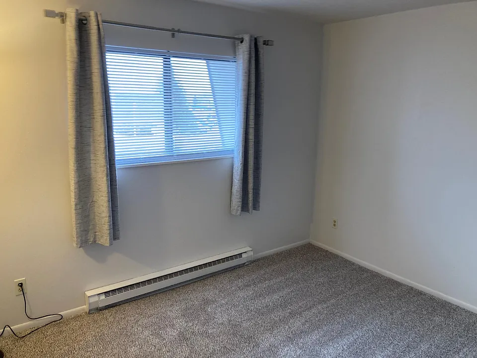 Large bedroom measures 12 by 14 feet. New mini blinds as well as drapes and electric baseboard heat with it own thermostat to keep the room comfortable.