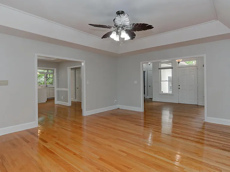 living room open to dining room kitchen and foyer