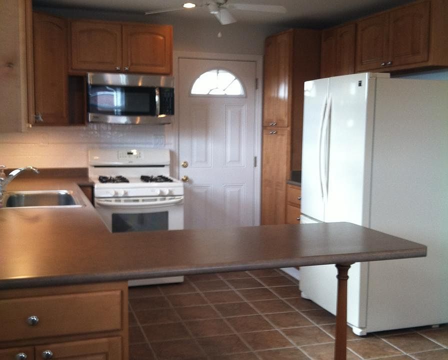 KITCHEN WITH DOOR TO SIDE PORCH.