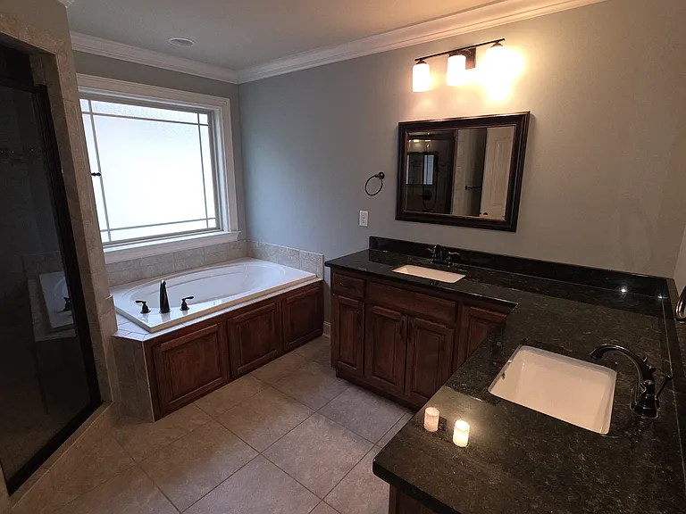 Master bath with double vanities and soaking tub