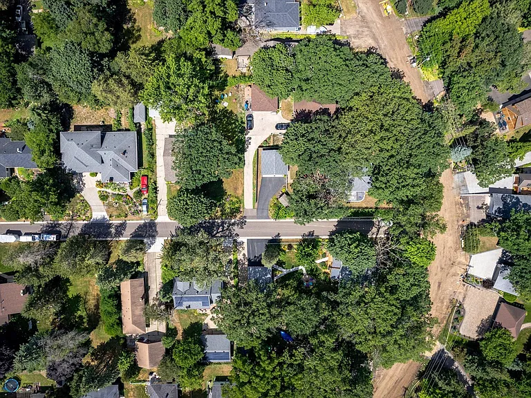 The driveway and garage are at the center of the photo and the one way road and bike path to the right are now paved. The lake access is about 500 yards up the road to the right. The houses on the right are lakefront.