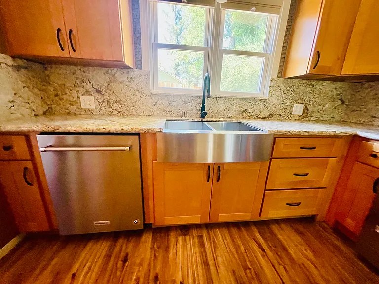 Modern updated kitchen with dishwasher, disposal and farmhouse sink