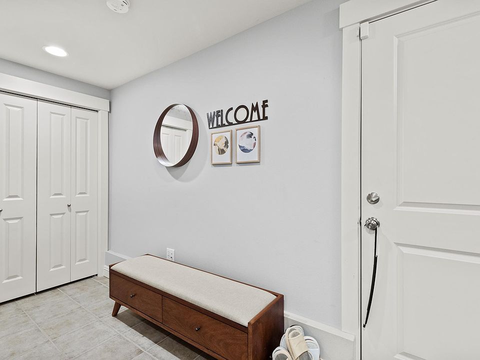 Large mudroom, laundry area, and garage on 1st floor. (Picture taken of another unit, same floor plan but mirror-imaged)
