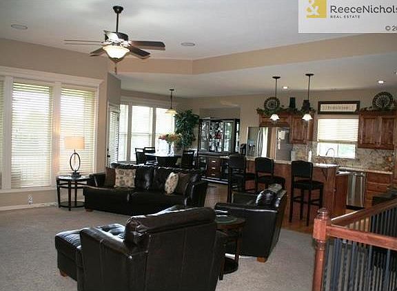 Open floor plan with hardwood floors in kitchen and dining area.  Iron spindles accents to lower level.