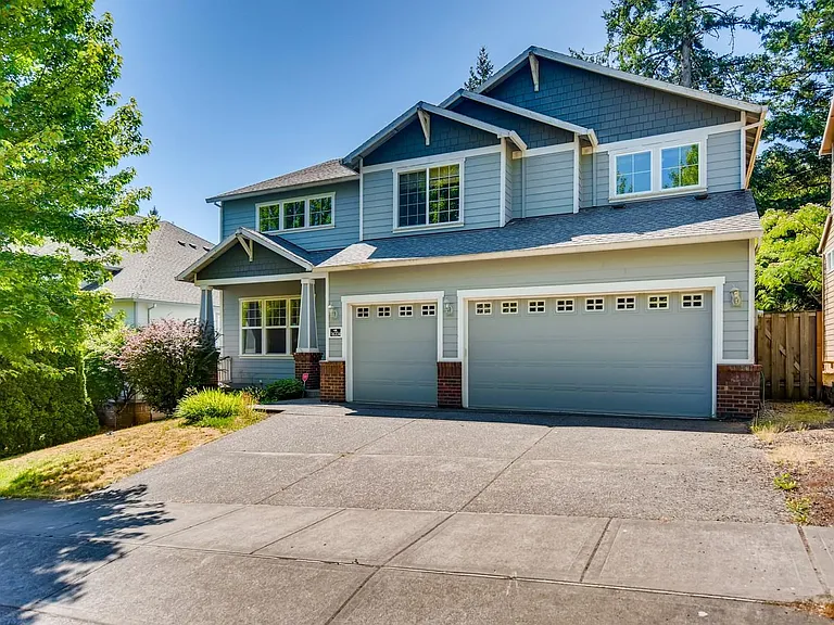 Gorgeous home with a lovely front porch and an oversized 3 car garage with storage.