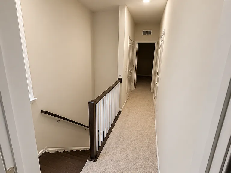 Hallway between master and second bedroom with large linen closet and washer dryer