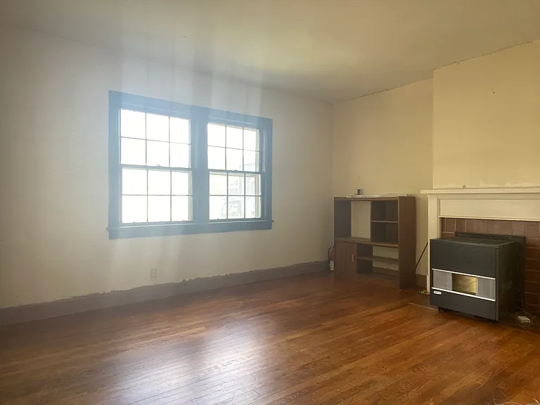 Living room looking at heater and front windows