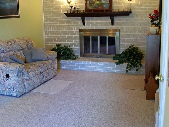 Wood Burning Fireplace with Brick Surround and Mantel