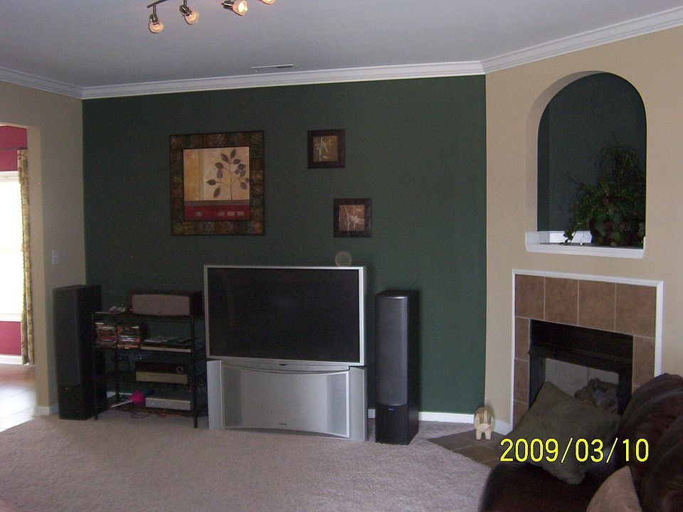 Living room w/arched entry way, corner Fplace with media niche.