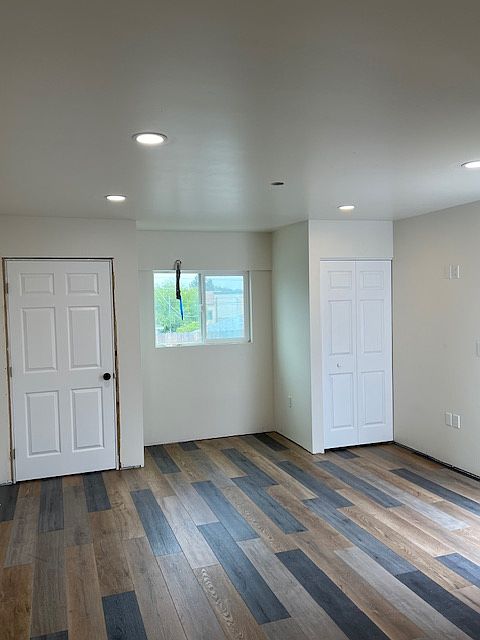 Left Door is 4' Closet. Right is Full Size Stacked Washer/Dryer Closet.
Also shows recessed LED Main Room Lighting & Vinyl Plank Flooring.