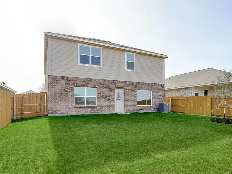 The back yard is fully fenced in.