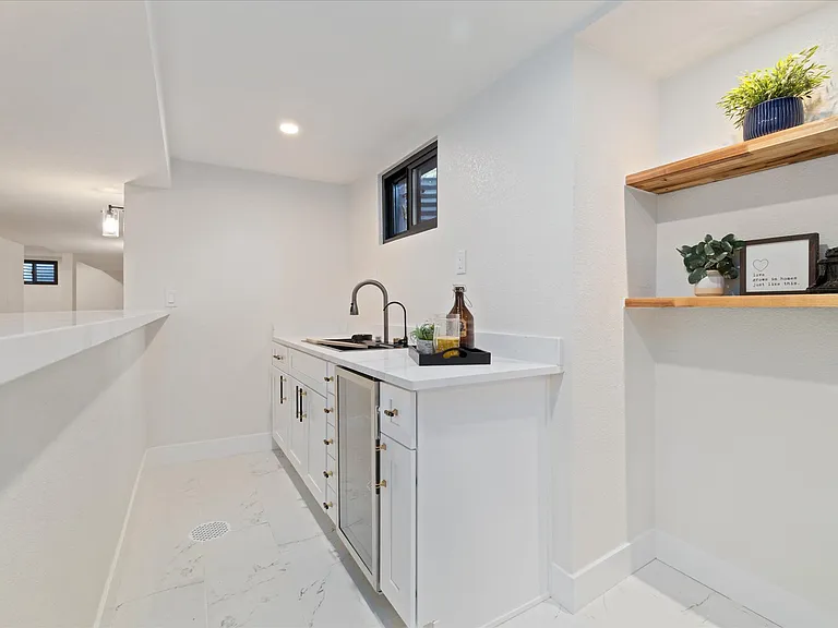 Wet bar in basement with wine cooler and Smart sink equipped with bottle cleaner