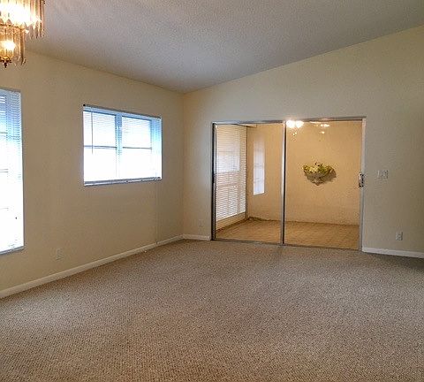 Large living/dining room with vaulted ceiling overlooking fa