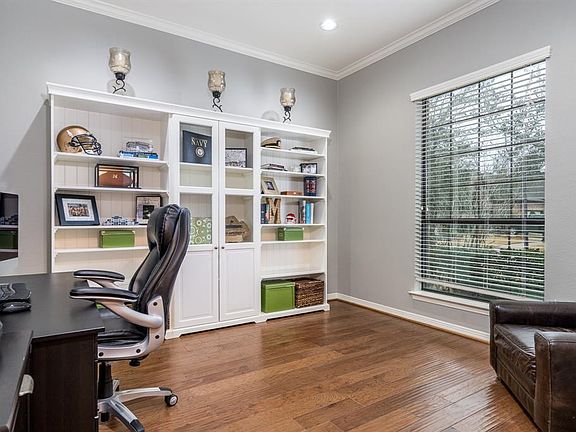 A private study with French doors and hardwood flooring is located at the front of the home.