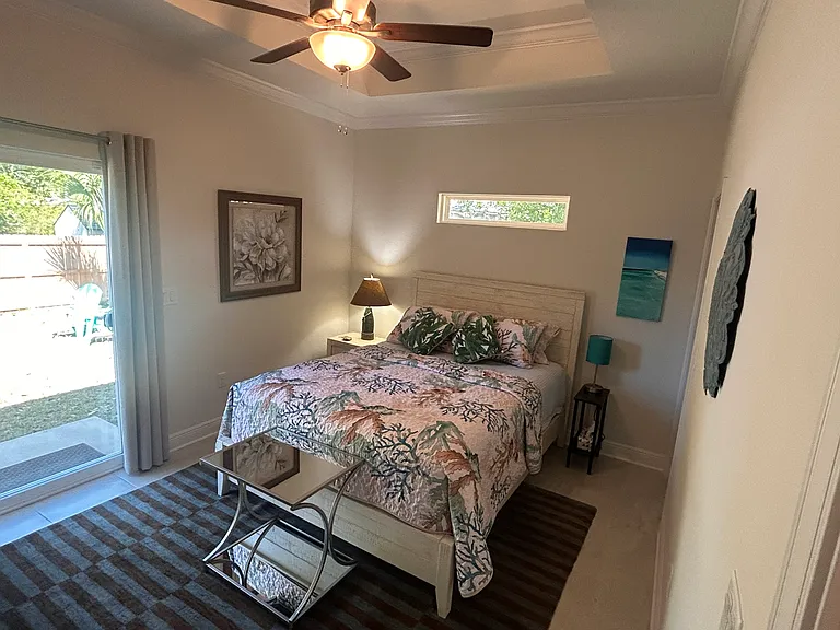 Owners suite with queen bed and access to back fenced yard