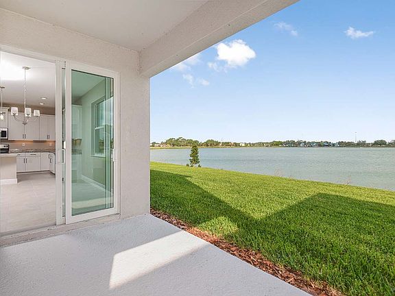 Juniper new home plan quick move-in waterfront homesite rear covered lanai at Tea Olive Terrace at t