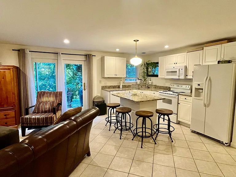 Living room, kitchen and kitchen island with breakfast bar