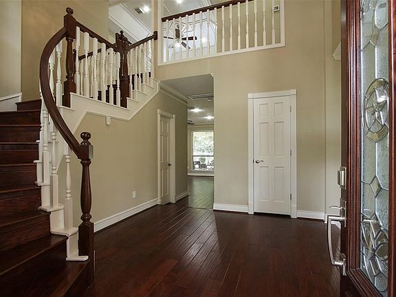 Beyond the leaded glass door, you will find beautiful wood flooring and neutral paint throughout the home.