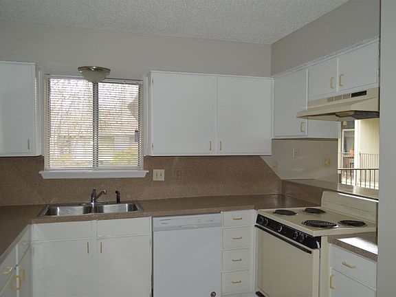 Kitchen with a view of the pool area and refinished/updated counter tops