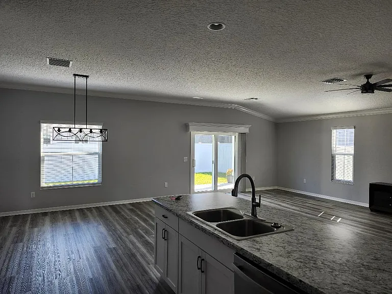 Living and dining area view from within kitchen