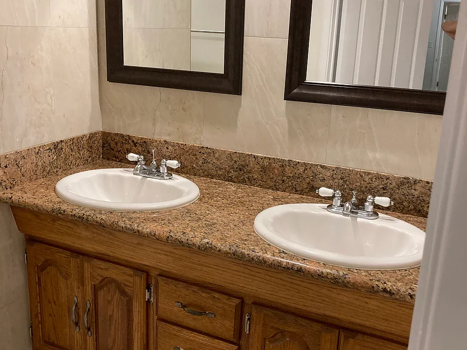 Master bathroom with double sink and mirrors. Medicine chest not shown but is to the right of mirrors.