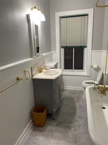 Upstairs full bath with clawfoot tub and shower - with new floor, cabinet and wainscoting - 615 Main St