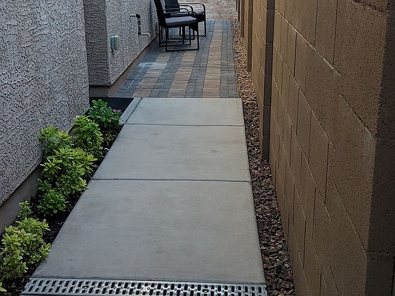 THE BLOCK WALL PROVIDES PRIVACY FROM NEIGHBORS. TWELVE FEET OF PAVERED WALKWAY PROVIDES ADDITIONAL OUTDOOR SPACE.