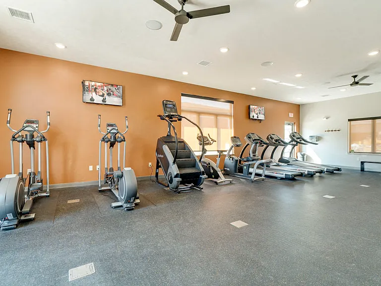 Our west clubhouse offers a second, expansive workout facility for residents with cardio equipment, weightlifting machines and free weights.
