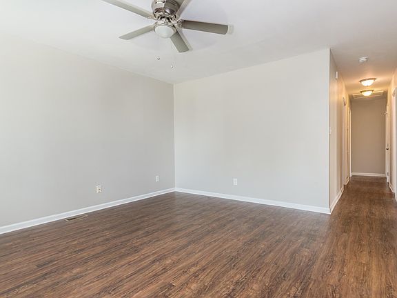Living room opens into hallway where bedrooms and main bathroom are located