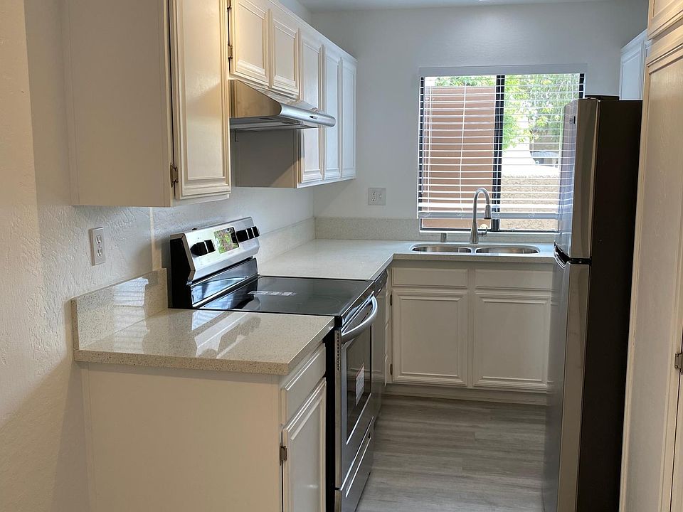 Kitchen w stainless appliances and view of pool