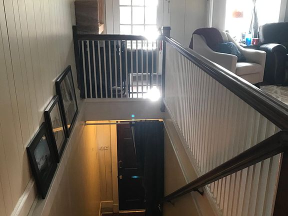 Front door and steps leading up to unit and door. Top door opens to the balcony.
