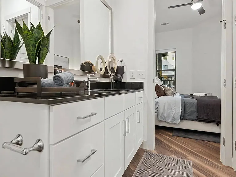 Apartment Bathroom with Sink Vanity and View Into Bedroom