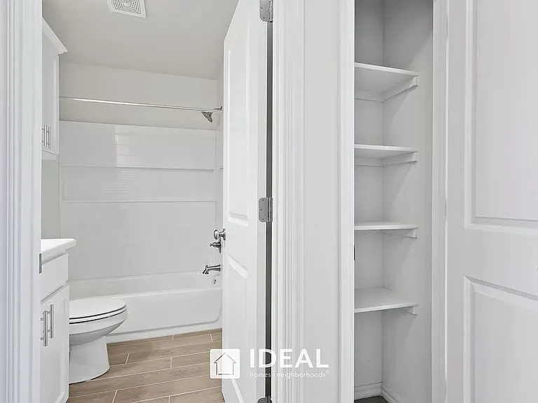 Linen closet and view to guest bathroom