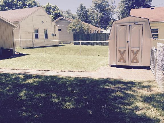 Partially shaded yard vintage brick patio and pathways