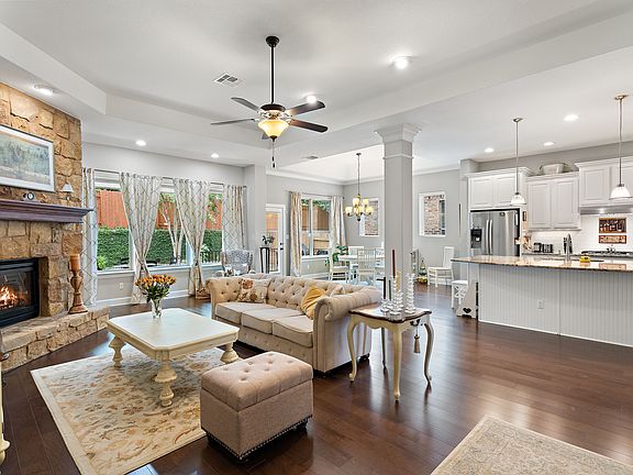 Open plan living with fireplace and stunning wood floors.