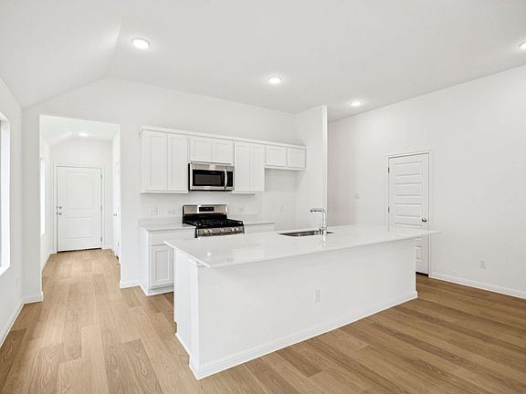 Kitchen in the Spruce home plan by Trophy Signature Homes - REPRESENTATIVE PHOTO