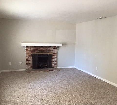 new carpet living room with fireplace