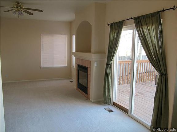Cozy family room with gas fireplace and ceiling fan