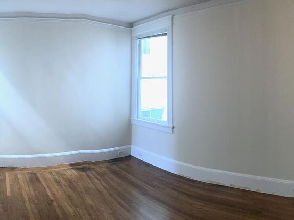 panorama picture of bedroom at back of unit with closet