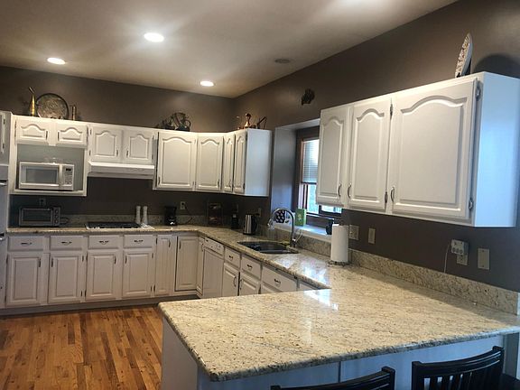 Spacious kitchen with lots of cabinets and counter space. With pantry and menu desk.