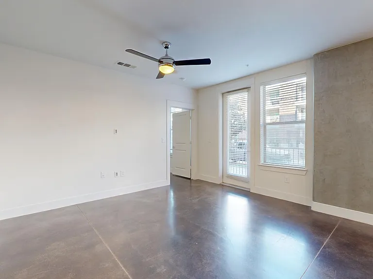 Apartment living room with polished concrete flooring.