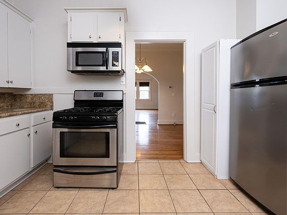 Kitchen with gas stove, microwave, pantry