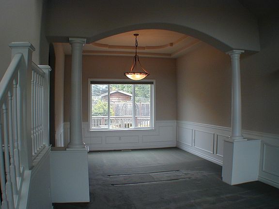 Dining Room. Coved ceilings, wainscoting, Hunter Douglas Duet blinds.