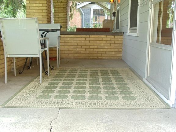 Front porch, large pine trees in yard provide privacy.