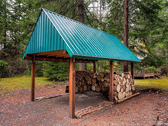 Recently built 200 SF carport fits a mid-size car and also allows room for drying out next season's firewood rounds.  There is additional wood storage out back of the tool shed.