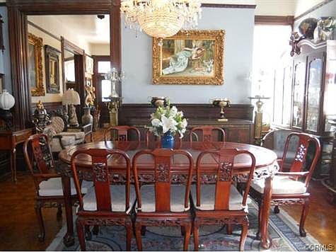 Very large formal dining room with chandelier, original wood flo